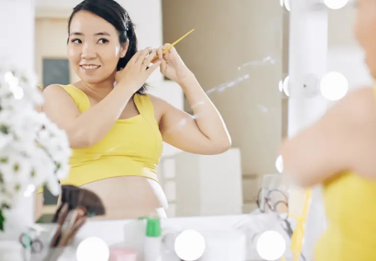 pregnant woman brushing her hair